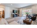 Comfortable living room featuring cozy seating and direct access to the outdoor patio at 17219 W La Luz Rd, Surprise, AZ 85387