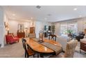 Open-concept living room and dining area with lots of natural light and neutral color palette at 17219 W La Luz Rd, Surprise, AZ 85387