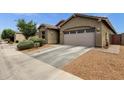 Home exterior featuring a two-car garage, tiled roof, and low-maintenance desert landscaping at 1725 E Chanute Pass --, Phoenix, AZ 85040