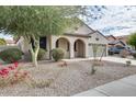 Charming single-story home with arched entryway and well-maintained desert landscaping at 17562 W Agave Ct, Goodyear, AZ 85338