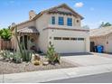 Charming two-story home featuring stucco exterior, tile roof, desert landscaping, and attached two-car garage at 18031 N 12Th Pl, Phoenix, AZ 85022