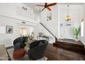 Bright living room featuring hardwood floors, a soaring ceiling, and staircase at 18031 N 12Th Pl, Phoenix, AZ 85022