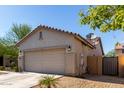 Side view of the house showing a garage, tile roof, and neutral stucco at 19342 W Morning Glory Dr, Buckeye, AZ 85326