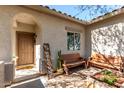 Inviting front porch with charming décor, seating, and a covered entrance at 19342 W Morning Glory Dr, Buckeye, AZ 85326