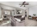 Bright open concept living room with tile flooring and modern ceiling fan at 19342 W Morning Glory Dr, Buckeye, AZ 85326