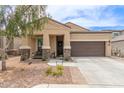 Beautiful single-Gathering home with desert landscaping, a two-car garage, and covered front porch at 1951 W Plum Rd, Phoenix, AZ 85085