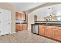 Bright kitchen with beautiful tile floors, stainless steel dishwasher and wooden cabinets at 209 E Diamond Trl, San Tan Valley, AZ 85143