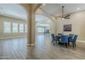 Open-concept living space featuring wood-look tile flooring, elegant archways, and recessed lighting at 22255 E Quintero Rd, Queen Creek, AZ 85142