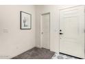 Bright entryway featuring white walls, decorative tile, and a cactus-themed picture at 2256 W Laurie Ln, Phoenix, AZ 85021