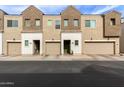 Row of modern townhomes with garages and desert landscaping add curb appeal at 2256 W Laurie Ln, Phoenix, AZ 85021