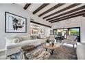 Inviting living room featuring exposed wood beams, stylish decor, and an open floor plan at 3109 E Sierra Madre Way, Phoenix, AZ 85016