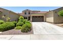 Inviting home featuring a two-car garage, well-kept landscaping, and a classic exterior design at 3554 N Hooper St, Buckeye, AZ 85396