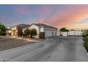 Single-story home with stone accents and a spacious driveway leading to a three-car garage at 3911 N 197Th Ave, Buckeye, AZ 85396
