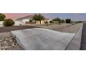Well-maintained single-story home with stone accents, mature trees, and extra parking at 3911 N 197Th Ave, Buckeye, AZ 85396
