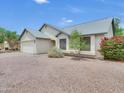Charming home featuring desert landscaping, mature trees, and a two-car garage at 3932 E Tierra Buena E Ln, Phoenix, AZ 85032