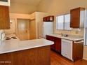 Functional kitchen with laminate countertops, wood cabinetry, and standard appliances at 3932 E Tierra Buena E Ln, Phoenix, AZ 85032