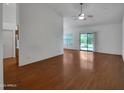 Spacious living room with beautiful wood floors, ceiling fan, and access to the backyard at 3932 E Tierra Buena E Ln, Phoenix, AZ 85032