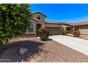 Inviting one-story home with desert landscaping, concrete driveway, and an attached two-car garage at 41103 W Rio Bravo Dr, Maricopa, AZ 85138
