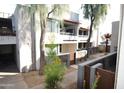 Well maintained property showing the exterior with green trees, a courtyard, and outdoor walkways at 4120 N 78Th St # 116, Scottsdale, AZ 85251