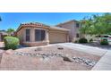 Well-maintained one-story residence featuring a desert-style front yard at 41812 W Sunland Dr, Maricopa, AZ 85138