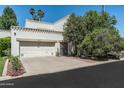 Charming two-story home featuring a two-car garage, desert landscaping, and blue sky at 4226 N 69Th Pl, Scottsdale, AZ 85251