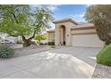 Desert home with decorative rock landscaping, covered entry, and attached two car garage at 4462 E Dale Ln, Cave Creek, AZ 85331