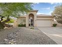 Inviting single-level home featuring desert landscaping, covered entryway, and a 2-car garage at 4462 E Dale Ln, Cave Creek, AZ 85331