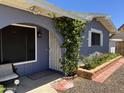 Inviting entryway with an arched trellis, brick planter, and wrought-iron security door at 4626 W Altadena Ave, Glendale, AZ 85304