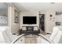 Cozy living room featuring a sleek TV, comfortable seating, and modern decor at 4898 N 206Th Ln, Buckeye, AZ 85396
