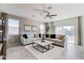 Comfortable living room showcasing plush sofas, neutral decor, and a ceiling fan at 4999 E Umber Rd, San Tan Valley, AZ 85143
