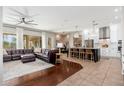 Open-concept living room with modern kitchen, a large sofa, and bright, natural light at 5712 E Blue Sky Dr, Scottsdale, AZ 85266