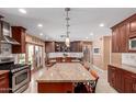 Bright kitchen featuring updated stainless steel appliances, a large island, and a seamless transition to the backyard at 6532 E Aster Dr, Scottsdale, AZ 85254