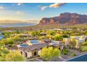 Beautiful aerial view of a desert home with stunning architecture and mountain views in the background at 6551 E Flat Iron Loop, Gold Canyon, AZ 85118