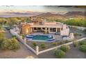 Backyard showcasing a private pool and spa, covered patio, built-in BBQ, and lush desert landscaping at 6551 E Flat Iron Loop, Gold Canyon, AZ 85118