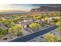 Southwest home boasts professionally landscaped grounds, mountain views, and a circular driveway at 6551 E Flat Iron Loop, Gold Canyon, AZ 85118