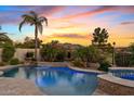 Stunning pool with waterfall feature and mountain views at sunset at 6706 S Jacqueline Way, Gilbert, AZ 85298