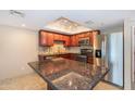This modern kitchen features stainless steel appliances and granite countertops at 7970 E Camelback Rd # 604, Scottsdale, AZ 85251