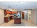 Updated kitchen features stainless steel appliances, center island, and an eat-in dining area at 7970 E Camelback Rd # 604, Scottsdale, AZ 85251