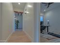 Hallway view leading to office and other rooms, featuring wood beams and neutral walls at 8214 N 16Th St, Phoenix, AZ 85020