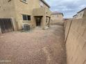 Spacious backyard with gravel, an AC unit, and a covered patio area at 9456 W Jamestown Rd, Phoenix, AZ 85037