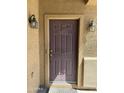 Close-up of a solid brown front door with side lanterns and a neutral colored facade at 9456 W Jamestown Rd, Phoenix, AZ 85037