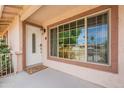Inviting front porch with white door and window, creating a warm and welcoming entrance at 10601 N 36Th St, Phoenix, AZ 85028