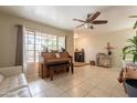 Bright and airy living room with a piano and a view of the outdoors at 10601 N 36Th St, Phoenix, AZ 85028