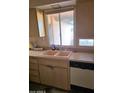 Kitchen sink with cabinets and a window overlooking the backyard at 1128 E Malibu E Dr, Tempe, AZ 85282