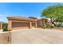 Spacious home with a three-car garage and large driveway at 11324 E Diamond Cholla Dr, Scottsdale, AZ 85255