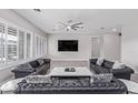 Spacious living area featuring plantation shutters and comfortable leather sofas at 11957 W Daley Ln, Sun City, AZ 85373
