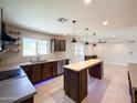 Bright kitchen boasting custom cabinetry, an island and tiled flooring at 12230 N 47Th Dr, Glendale, AZ 85304
