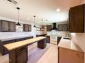 Spacious kitchen featuring an island, custom cabinetry, and modern appliances at 12230 N 47Th Dr, Glendale, AZ 85304