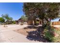 Welcoming single-story home with brick accents, two-car garage, mature trees and landscaping at 13041 N 51St Dr, Glendale, AZ 85304