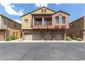 Three-story townhome features stucco, garages, stone accents, and a charming balcony at 1350 S Greenfield Rd # 1005, Mesa, AZ 85206